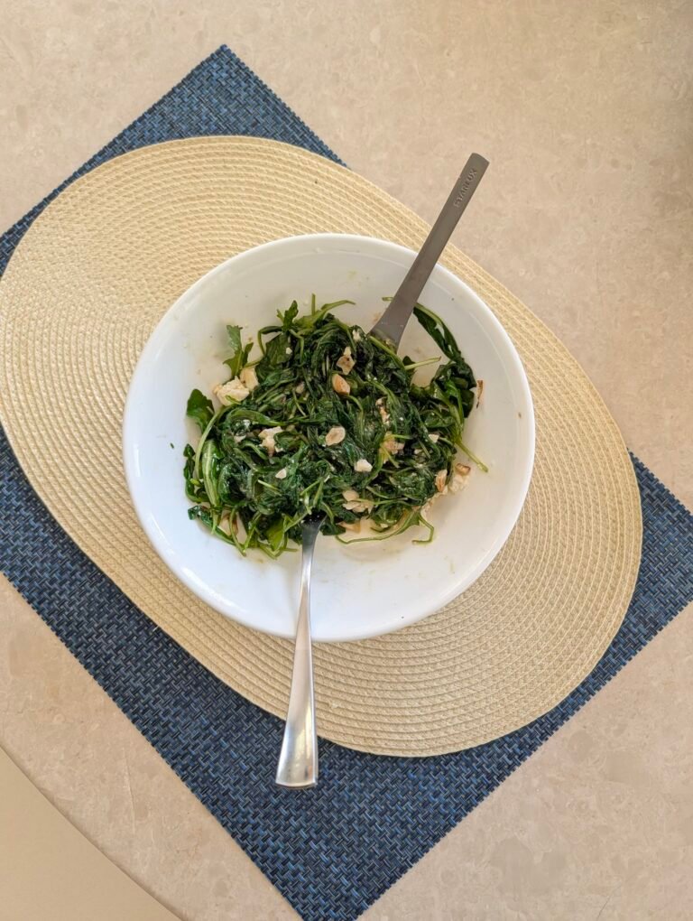 Honey trap mango arugula salad with feta in a white bowl